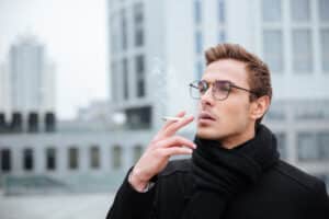 A man with erectile dysfunction smoking a cigarette