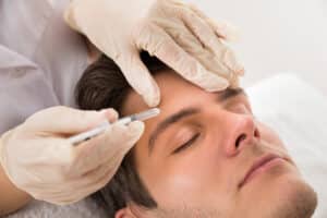 A man getting BOTOX® in his forehead